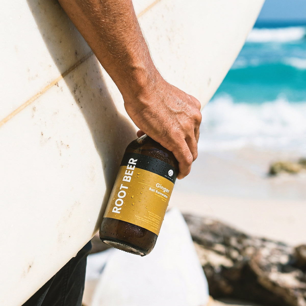 Person drinking Bali Rain Ginger Root Beer outdoors, clean low sugar ginger beer on the go Bali