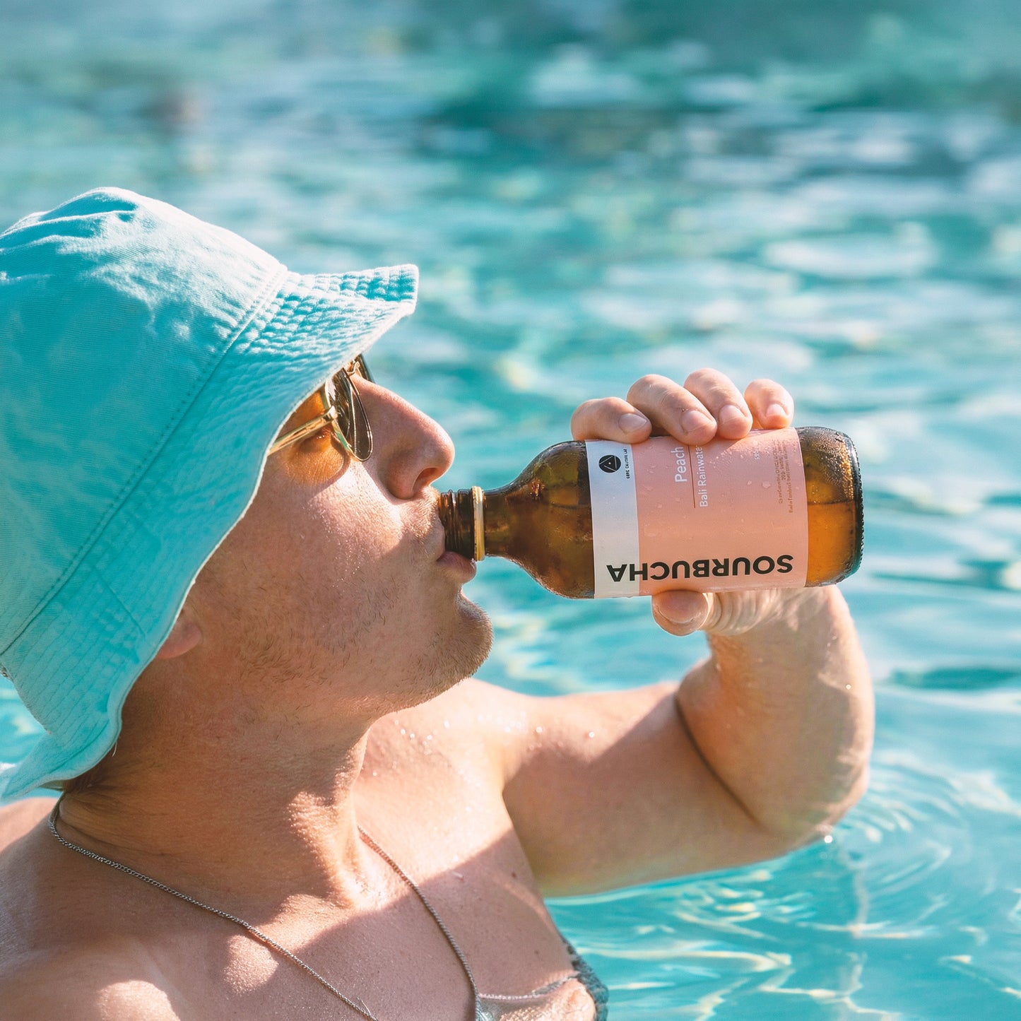 Man drinking Bali Rain Sourbucha™ Peach outdoors, healthy gut drink on the go Bali