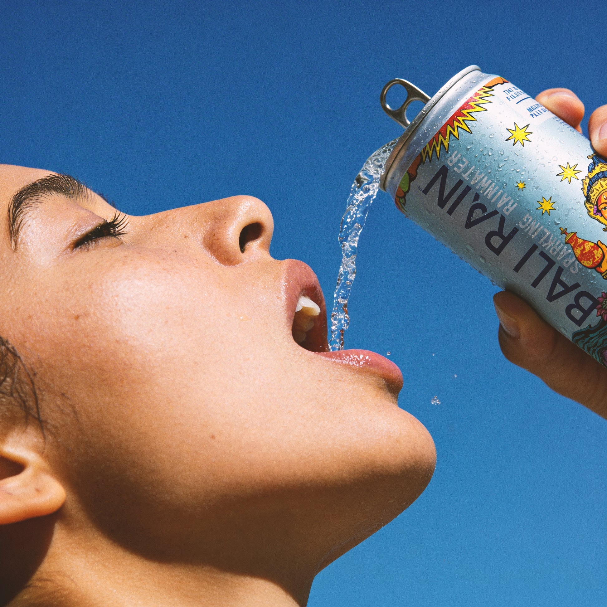 Person drinking Bali Rain Sparkling Rainwater outdoors, clean sparkling water on the go Bali